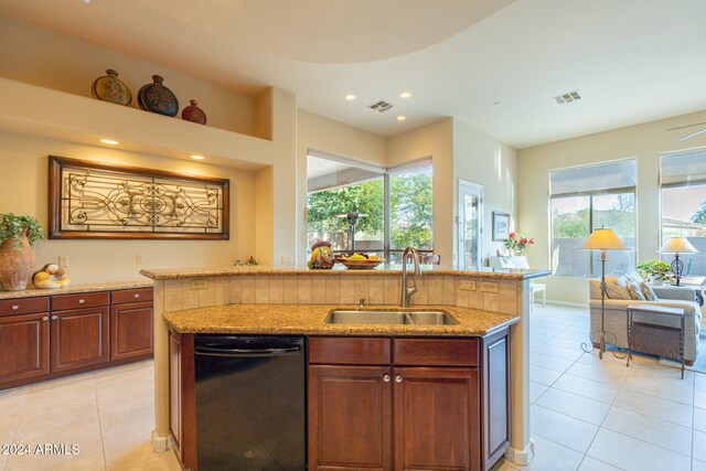 kitchen featuring stainless steel dishwasher, sink, an island with sink, and plenty of natural light