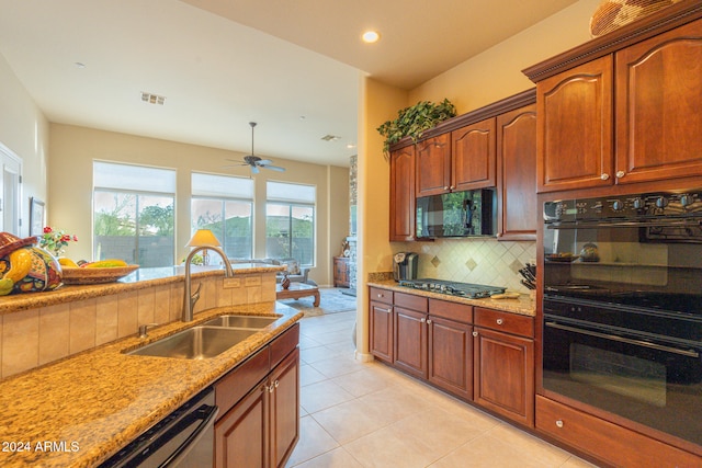 kitchen with tasteful backsplash, light stone counters, ceiling fan, black appliances, and sink