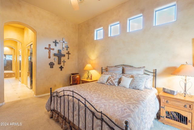 carpeted bedroom featuring connected bathroom and ceiling fan