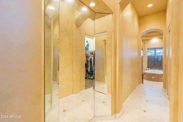 hall featuring light tile patterned flooring