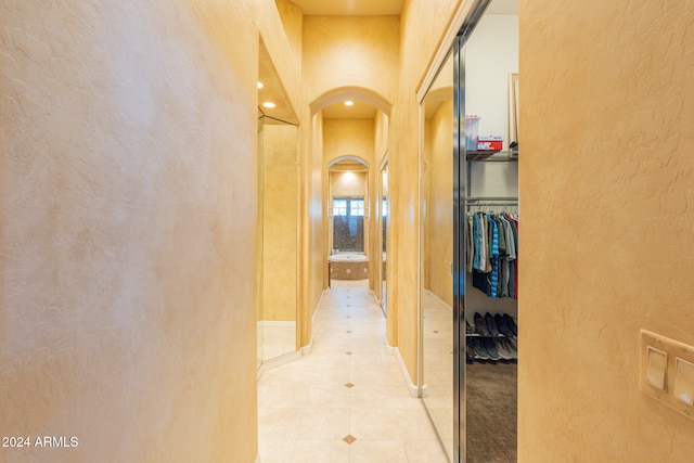 hallway featuring light tile patterned floors