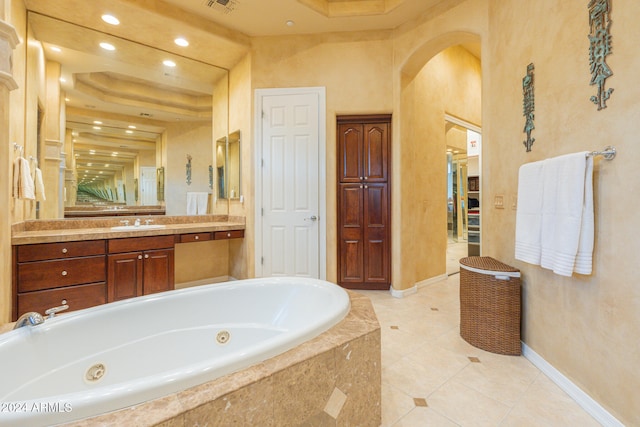 bathroom with vanity, tiled bath, and tile patterned floors