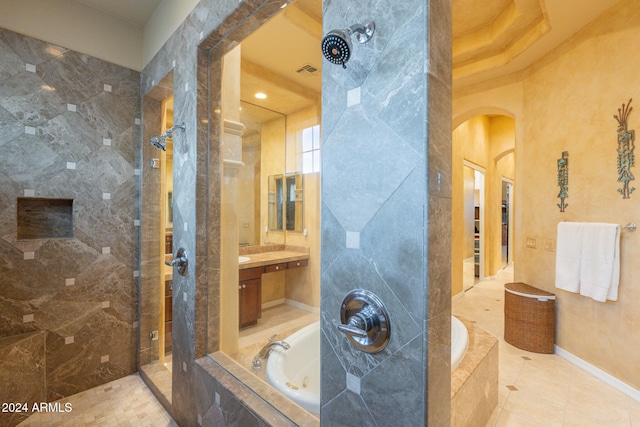 bathroom featuring vanity, independent shower and bath, and tile patterned flooring