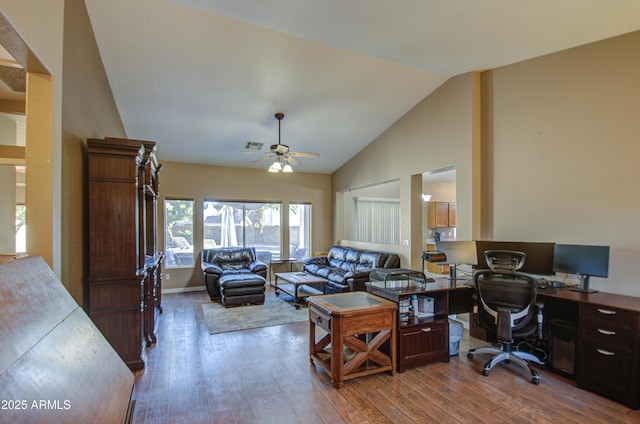 office space featuring ceiling fan, high vaulted ceiling, and light hardwood / wood-style flooring