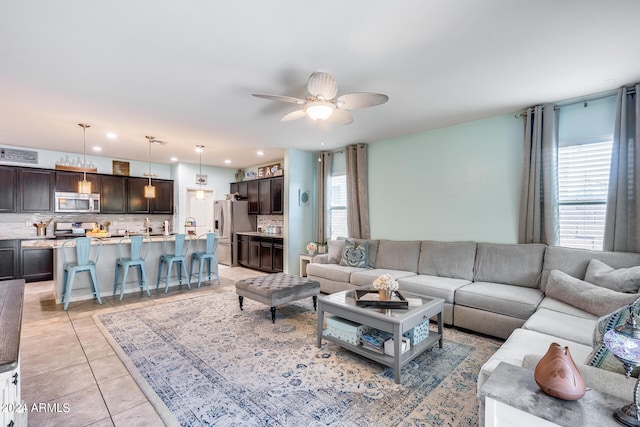 living room featuring ceiling fan and light tile patterned floors