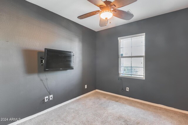 unfurnished room with ceiling fan and carpet floors