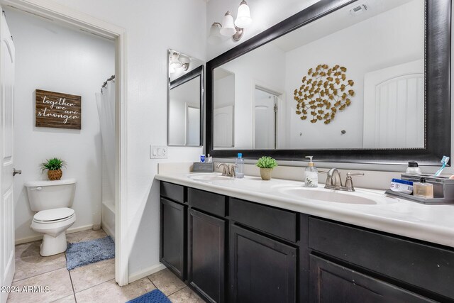 full bathroom featuring tile patterned flooring, vanity, toilet, and shower / bath combo with shower curtain