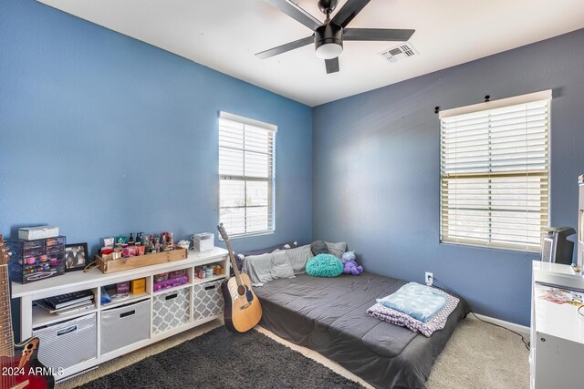 bedroom with ceiling fan and carpet