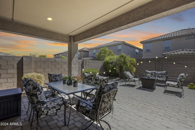 patio terrace at dusk featuring outdoor lounge area