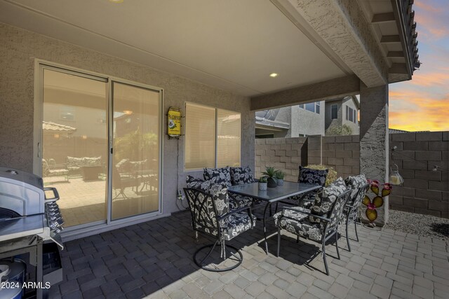 view of patio terrace at dusk