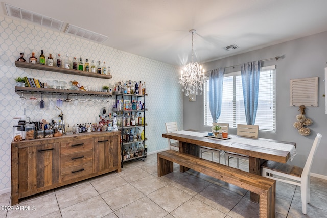 dining space featuring light tile patterned floors and a chandelier