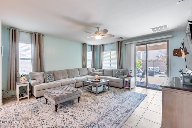 living room featuring ceiling fan and light tile patterned floors