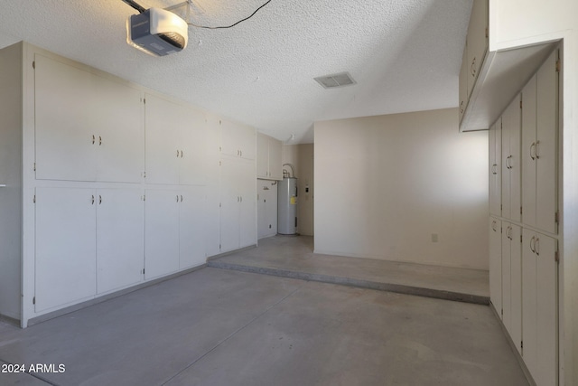 garage featuring electric water heater and a garage door opener