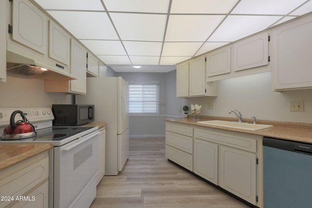 kitchen featuring electric range, a drop ceiling, dishwasher, sink, and light hardwood / wood-style flooring