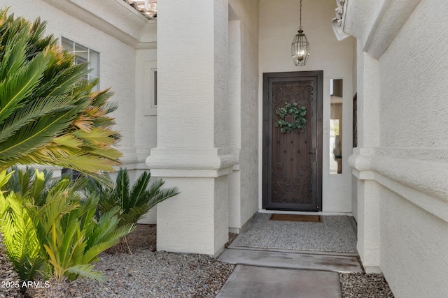 view of exterior entry featuring stucco siding