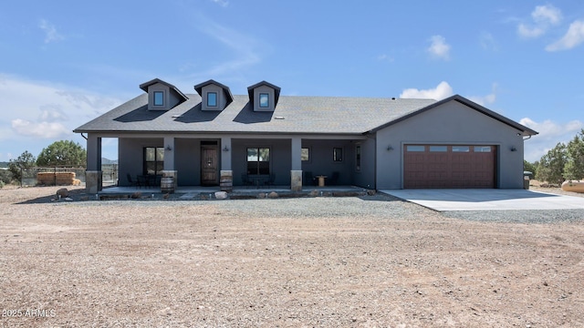 view of front of property featuring covered porch and a garage