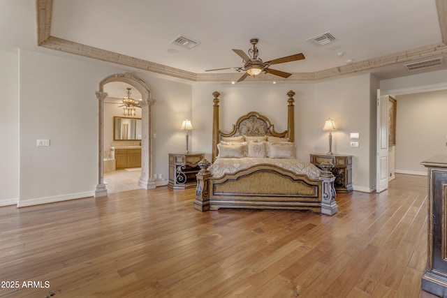 bedroom with light wood-type flooring, visible vents, and baseboards