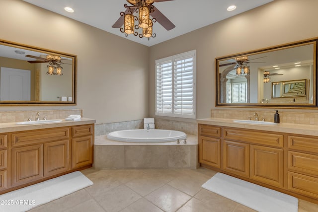 full bathroom with tile patterned floors, a ceiling fan, and a sink