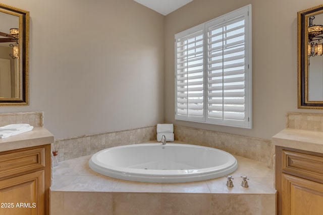 bathroom featuring two vanities and a jetted tub