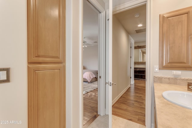 bathroom featuring visible vents, ensuite bathroom, tile patterned flooring, baseboards, and vanity