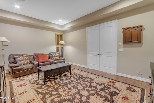 living room with recessed lighting, light wood-style floors, and baseboards