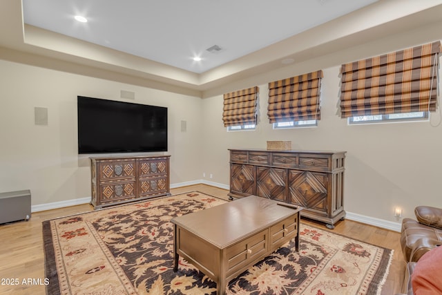 living room with light wood-type flooring, visible vents, baseboards, and recessed lighting