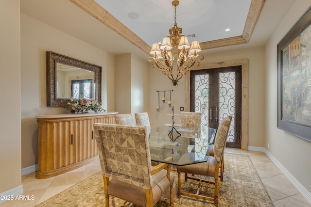 dining space featuring baseboards, a tray ceiling, french doors, an inviting chandelier, and light tile patterned flooring