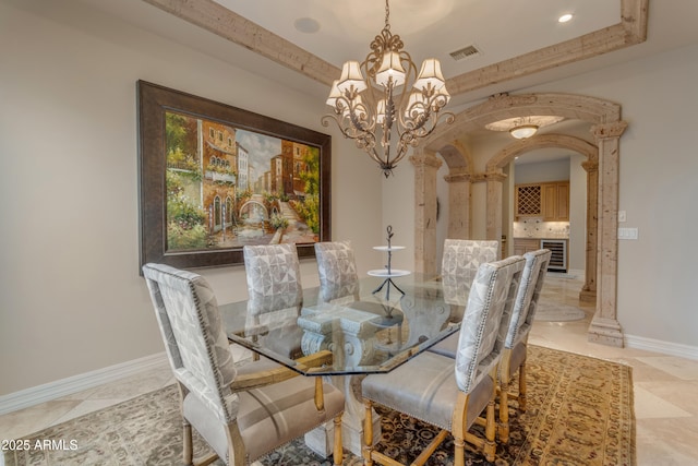 dining room with visible vents, arched walkways, baseboards, and a chandelier