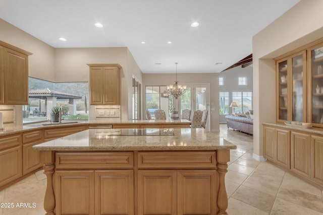 kitchen featuring a sink, a center island, recessed lighting, black electric stovetop, and a chandelier