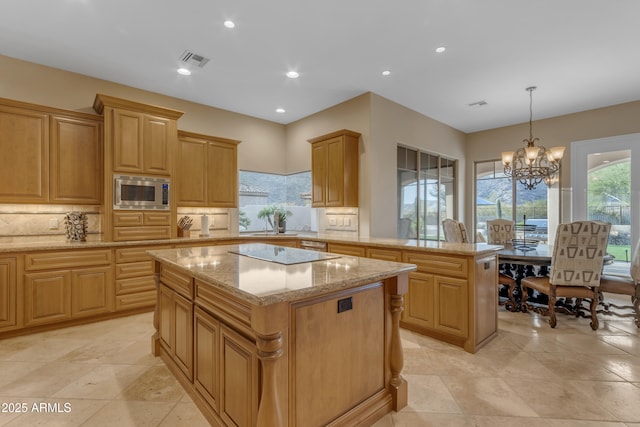 kitchen featuring visible vents, stainless steel microwave, tasteful backsplash, a kitchen island, and black electric cooktop