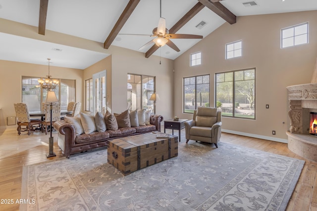 living room featuring visible vents, a premium fireplace, high vaulted ceiling, beam ceiling, and light wood-type flooring