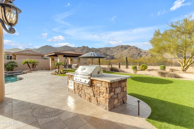 view of patio featuring a gazebo, area for grilling, and a fenced backyard