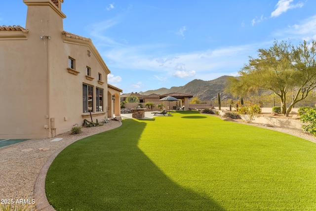 view of yard featuring a gazebo, a mountain view, a patio, and fence