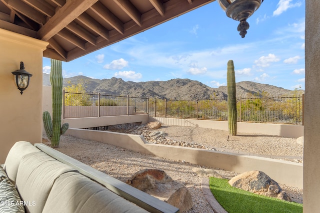 exterior space with a mountain view and fence