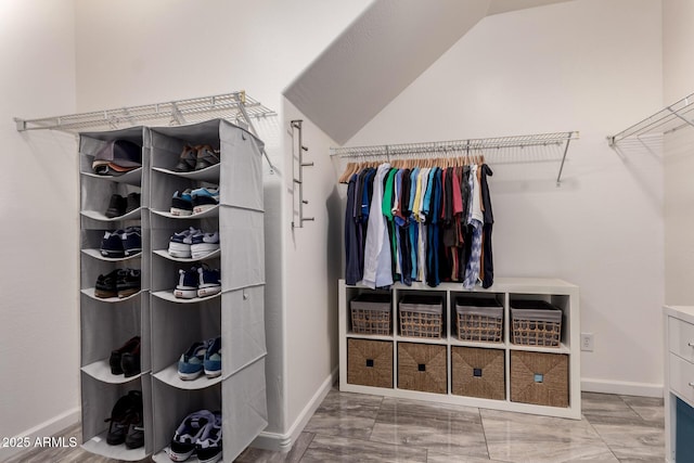 walk in closet with lofted ceiling