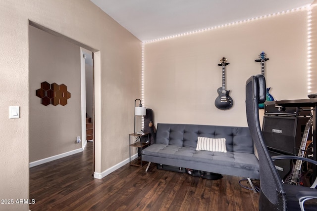 sitting room featuring baseboards and wood finished floors