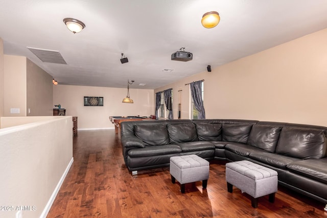 living area featuring dark wood-style flooring, baseboards, and visible vents