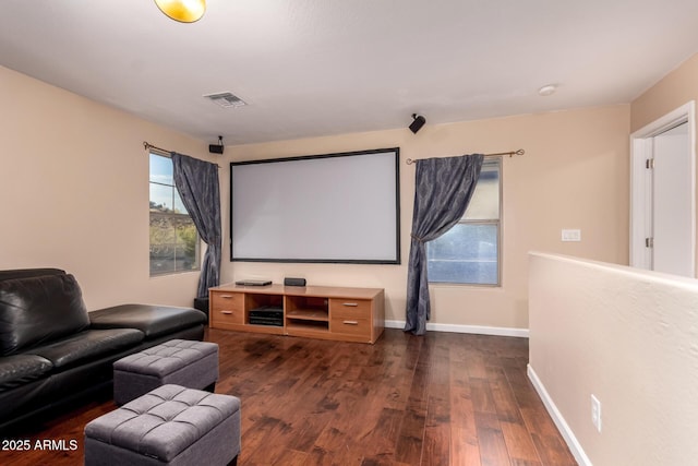 cinema featuring dark wood-style flooring, baseboards, and visible vents