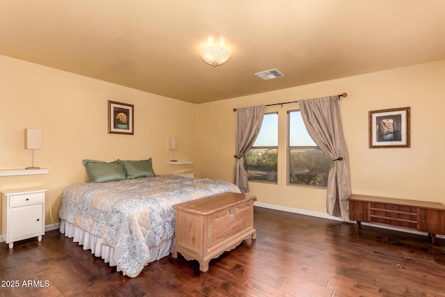 bedroom featuring baseboards, dark wood-type flooring, and visible vents
