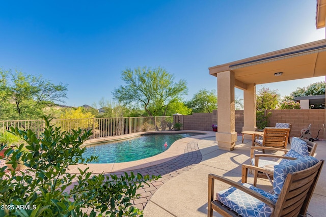 view of swimming pool featuring a patio area, a fenced in pool, and a fenced backyard
