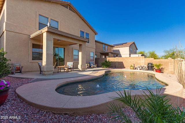view of swimming pool featuring a patio area, a fenced in pool, and a fenced backyard