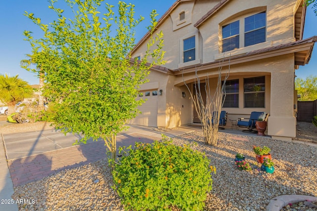 traditional home with stucco siding and a garage