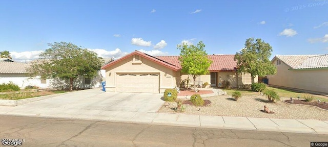 ranch-style house featuring a garage, a tiled roof, concrete driveway, and stucco siding