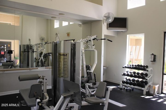 gym with a towering ceiling