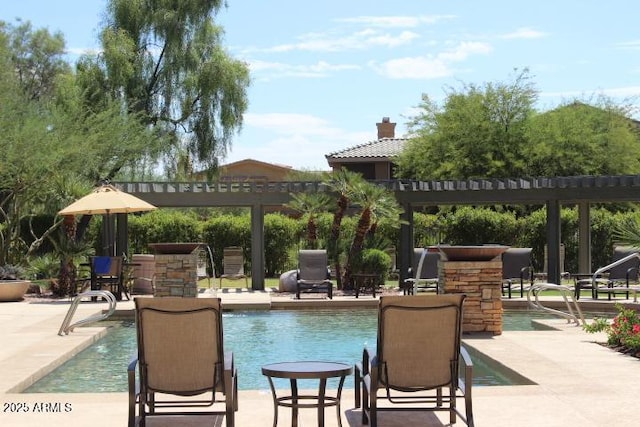 view of pool with a pergola and a patio