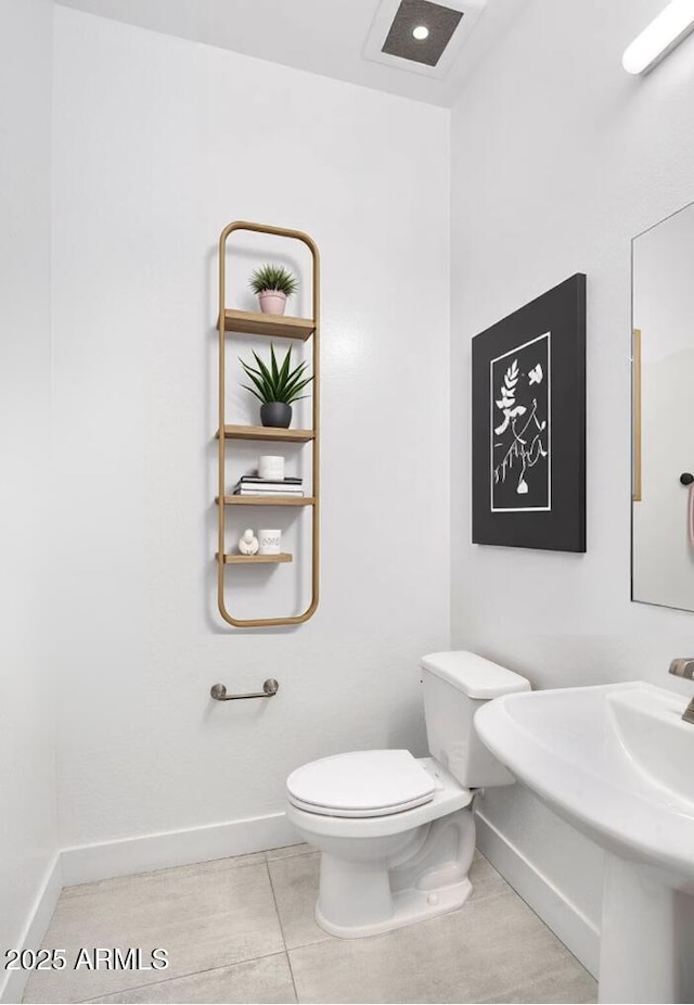 812 E Summerside Rd, Phoenix, AZ 85042 - half bathroom with baseboards, toilet, and tile patterned flooring