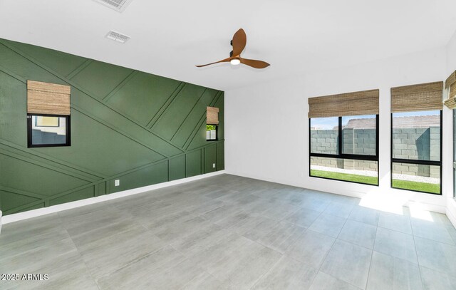 812 E Summerside Rd, Phoenix, AZ 85042 - tiled spare room with a decorative wall and a ceiling fan