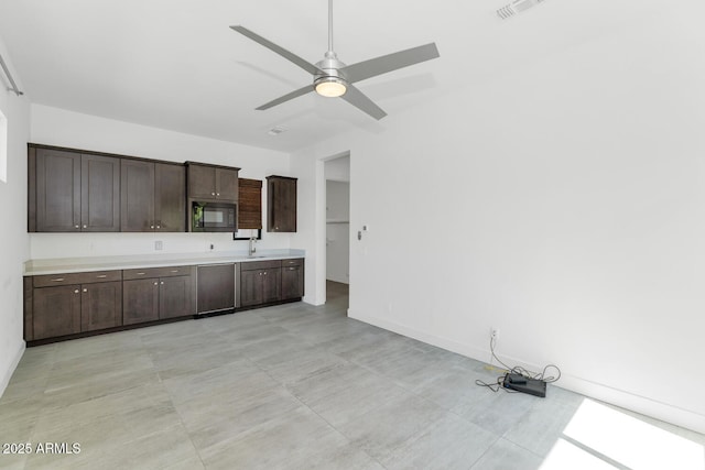 812 E Summerside Rd, Phoenix, AZ 85042 - kitchen featuring black microwave, dark brown cabinets, a ceiling fan, light countertops, and baseboards