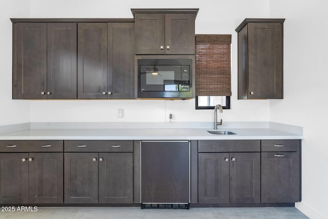 812 E Summerside Rd, Phoenix, AZ 85042 - kitchen with black microwave, a sink, dark brown cabinets, dishwashing machine, and light countertops