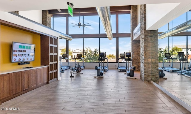 812 E Summerside Rd, Phoenix, AZ 85042 - exercise room with ceiling fan, wood finished floors, healthy amount of natural light, ornate columns, and a towering ceiling